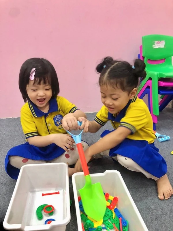 Two Guru students exploring a hands-on classroom activity