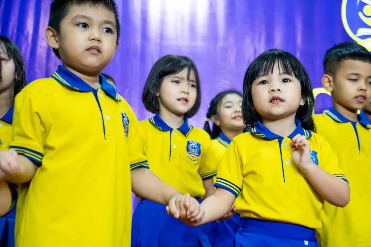 Guru children performing together in their school uniforms