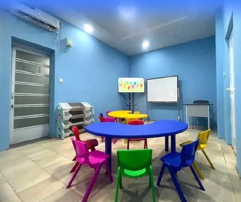 Early years classroom with colourful tables and chairs
